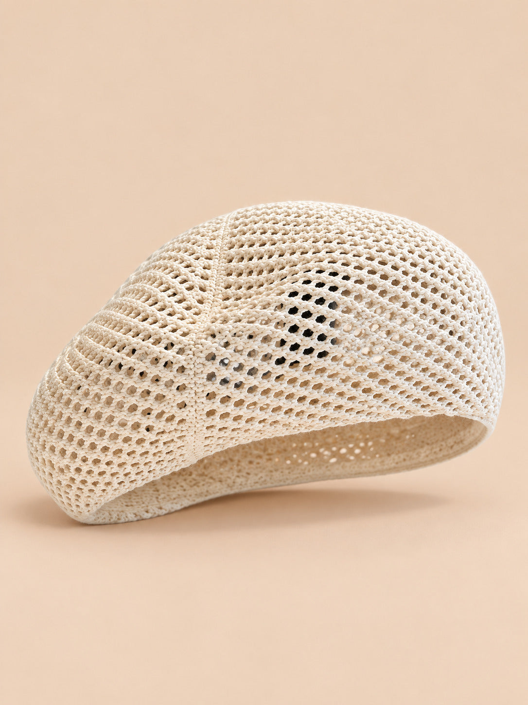 Béret bibi résille crème, vue de face sur fond pêche sable