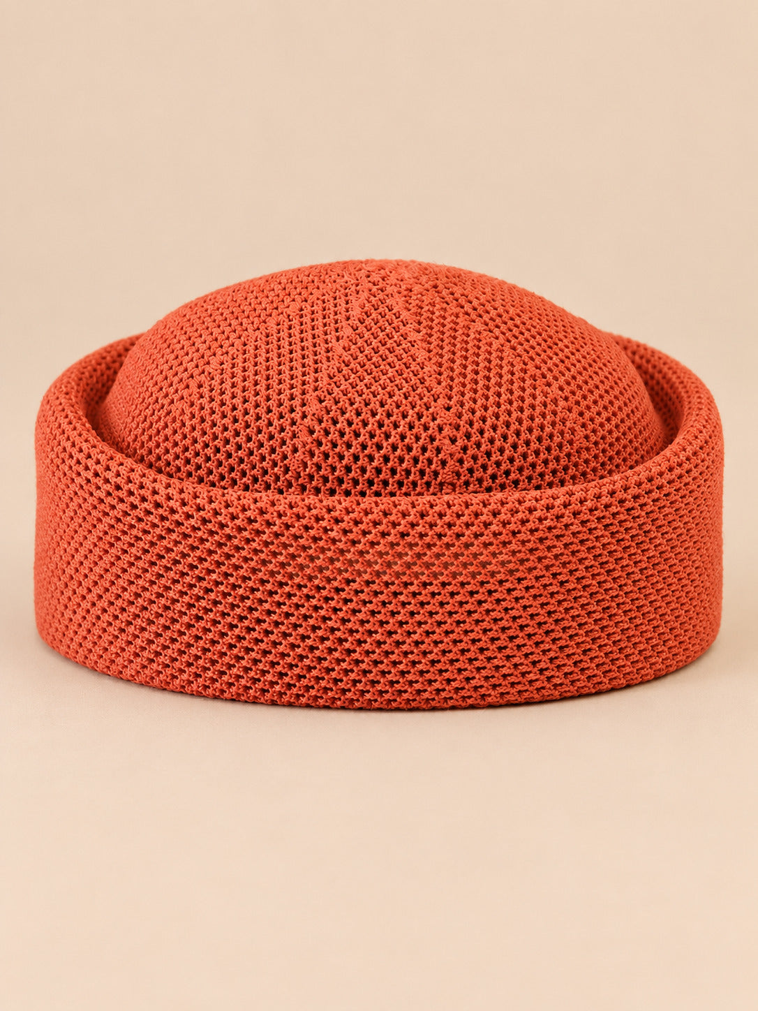 Béret rétro crochet Modèle 2 rouge orangé, vue de face sur fond pêche sable
