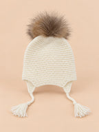 Mütze aus dem Mütze-Schal-Set für Kinder – Farbvariante Weiß, Ansicht von vorn, sand-pfirsichfarbener Hintergrund